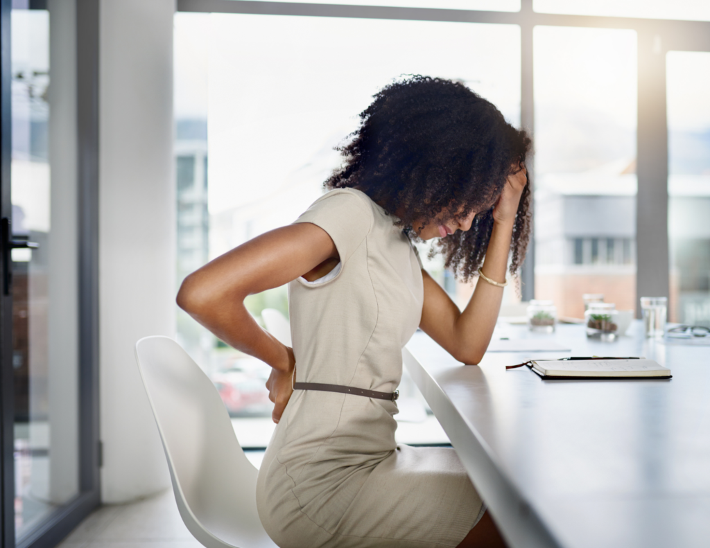 sitting at desk with pain